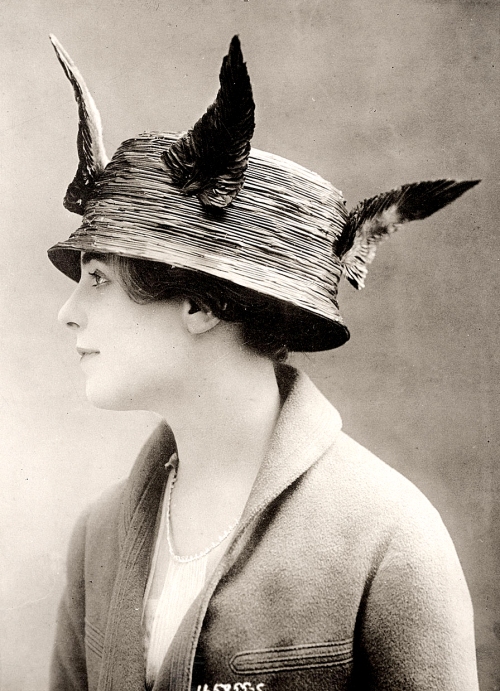 A woman in a feathered hat
